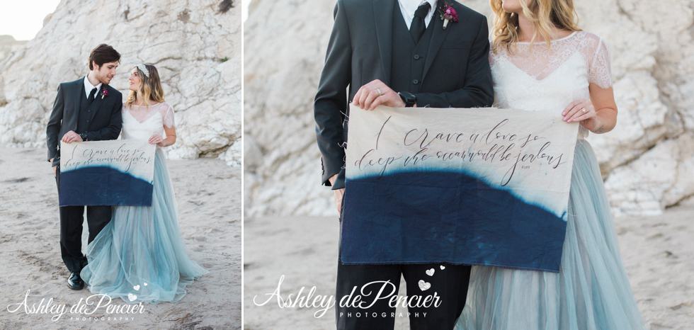 Handmade calligraphy sign being held by bride and groom