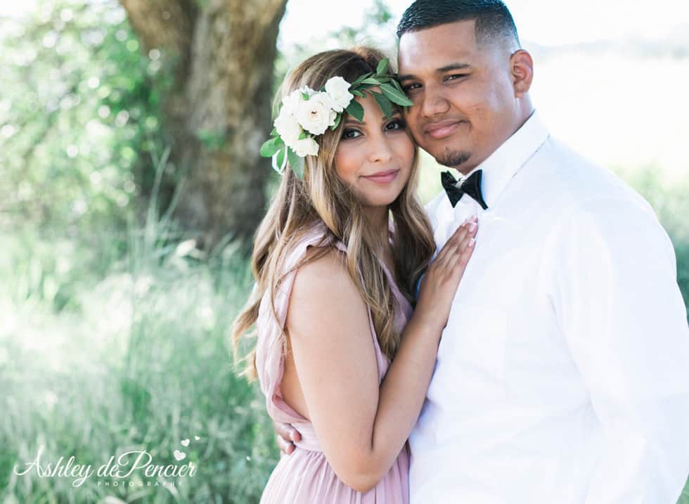 A couple posing outside for engagement portraits