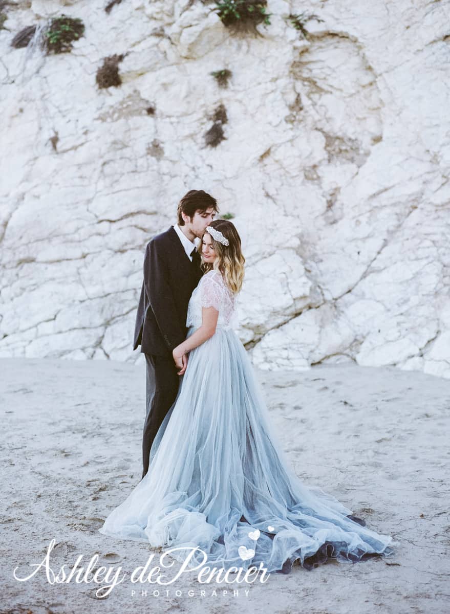 Bride and groom standing on the beach