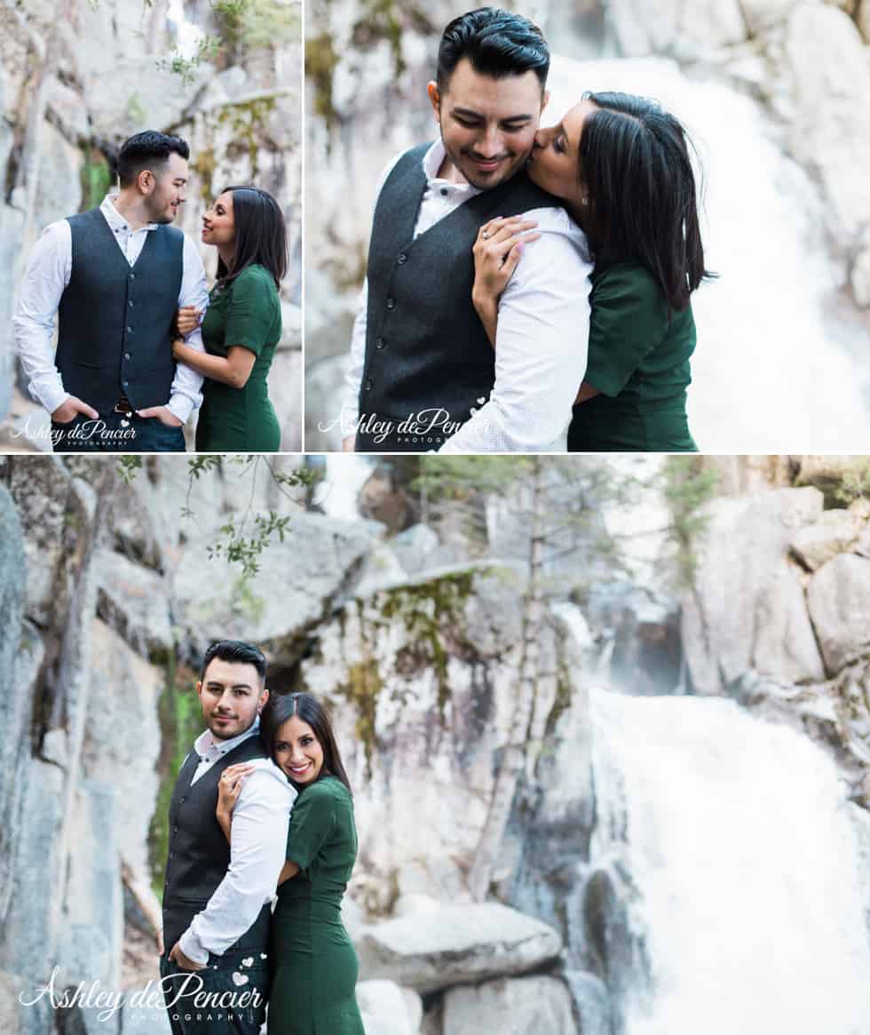 A couple standing by a waterfall