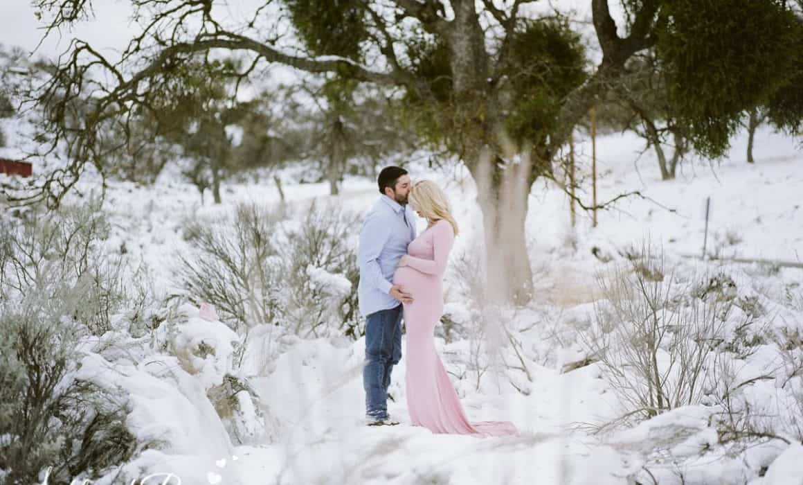 Husband kissing his wife's forehead