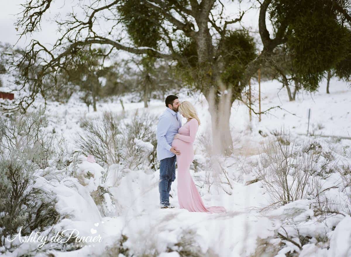 Husband kissing his wife's forehead