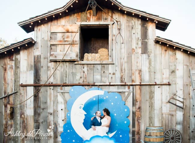 Couple sitting in front of a barn