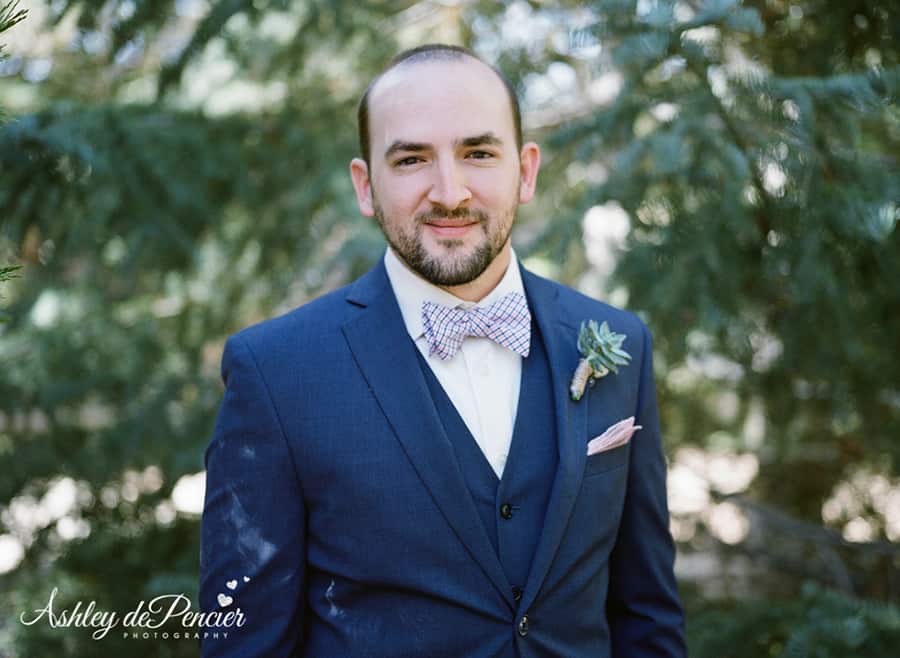 Portrait of a groom in a navy blue suit