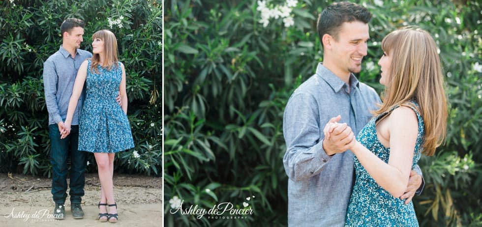 engaged couple posing for an outdoor portrait