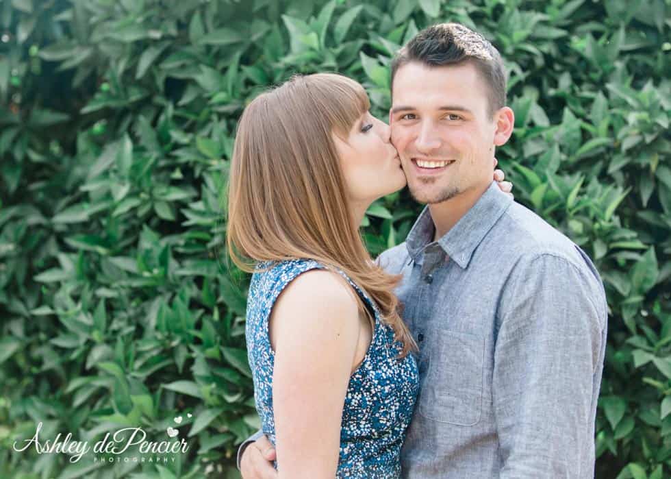 bride to be kissing her fiance